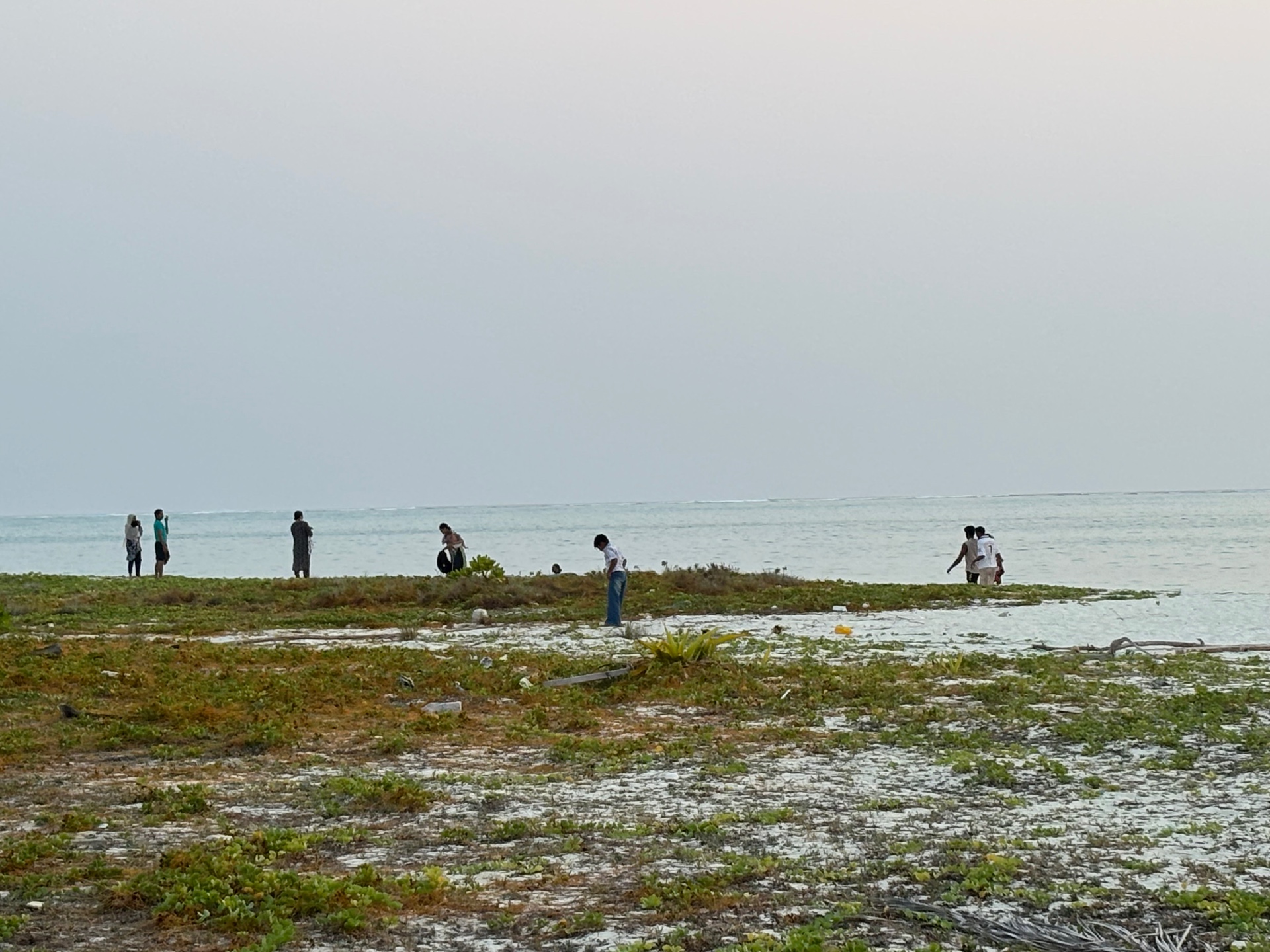 Islanders gathered at a quiet Lakshadweep lagoon at low tide